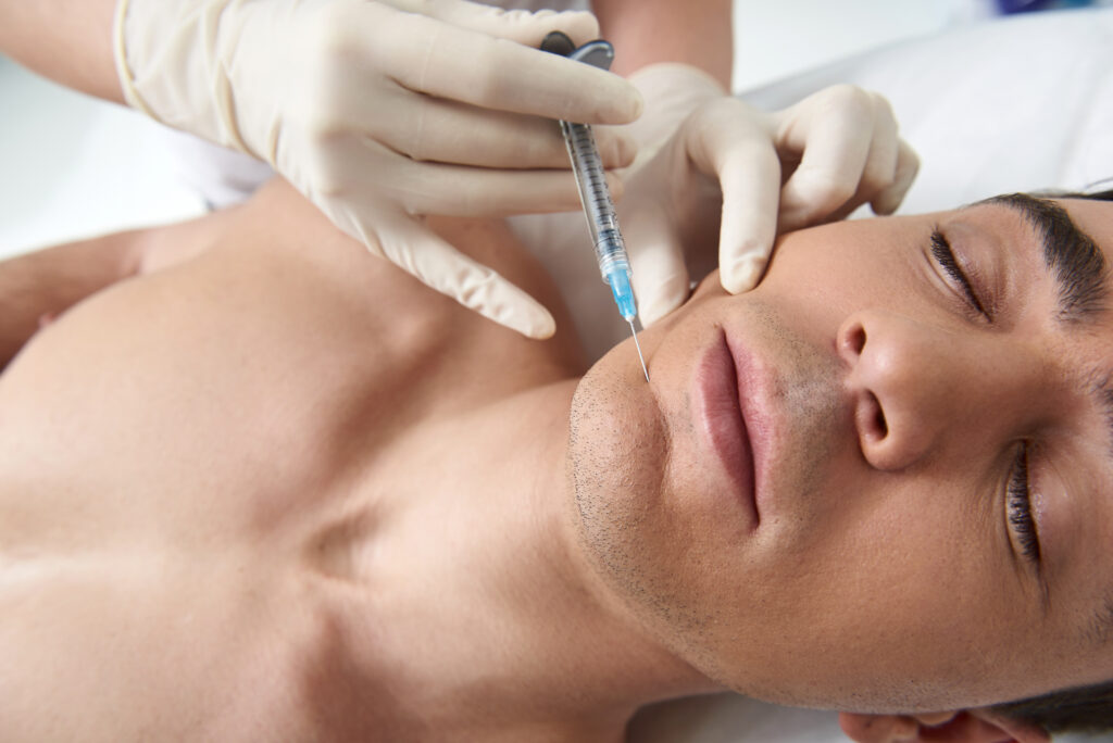 Man getting cosmetic injection of botox on chin. Man in Clinic | Skin Haven Cosmetic Clinic Vitality in Seattle, Wa